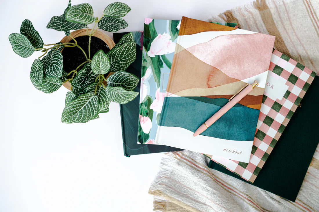 Pen on top of a stack of journals