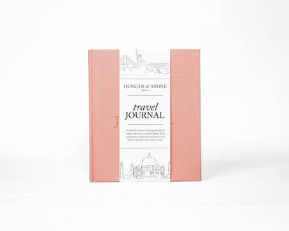 Pink travel journal with white cover on a white background